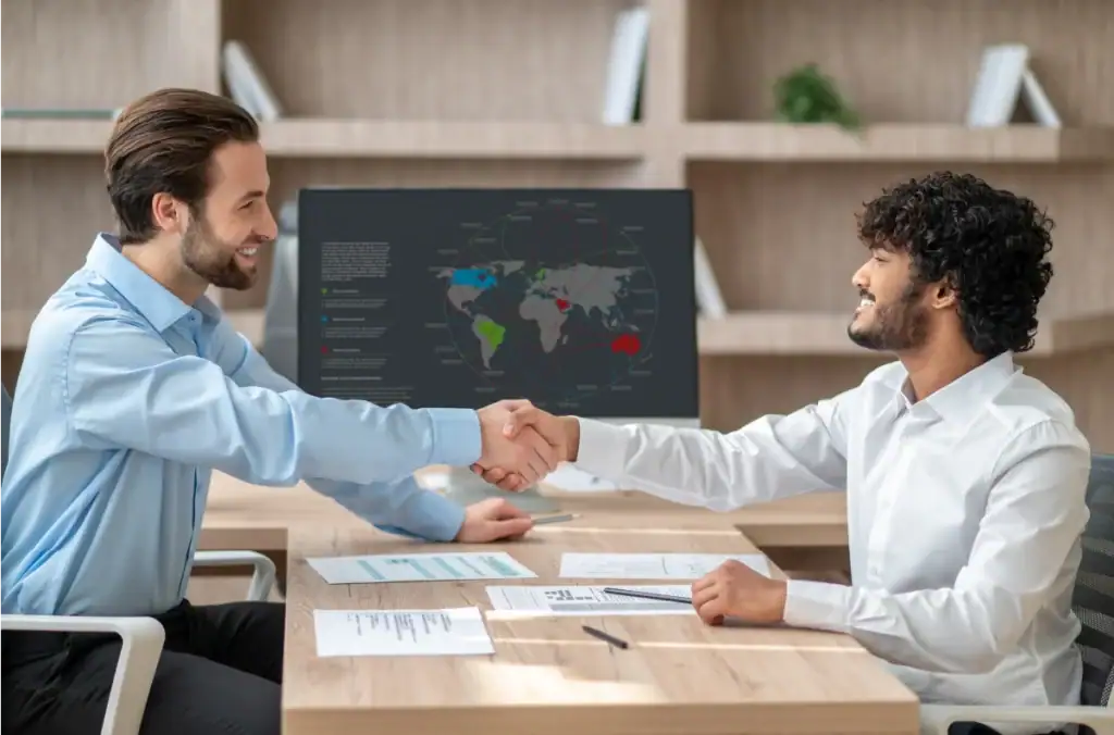 Business meeting with handshake and map.